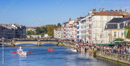 Panorama of people enjoying the sun while watching the boat race in Bayonne, France photo