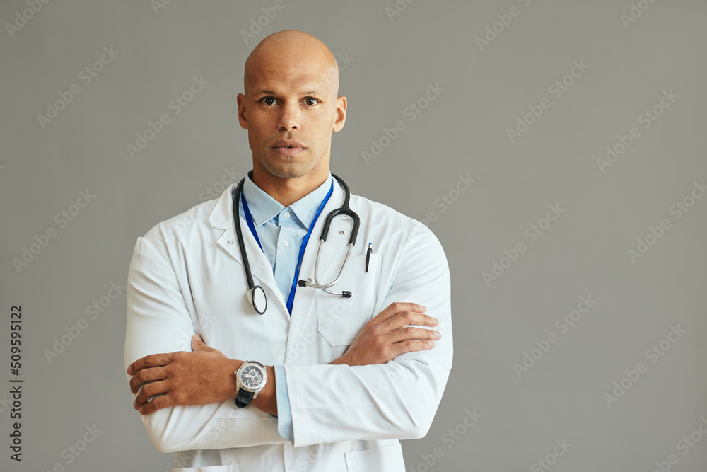 Studio portrait of confident black doctor looking at camera. Studio portrait of confident black doctor looking at camera.