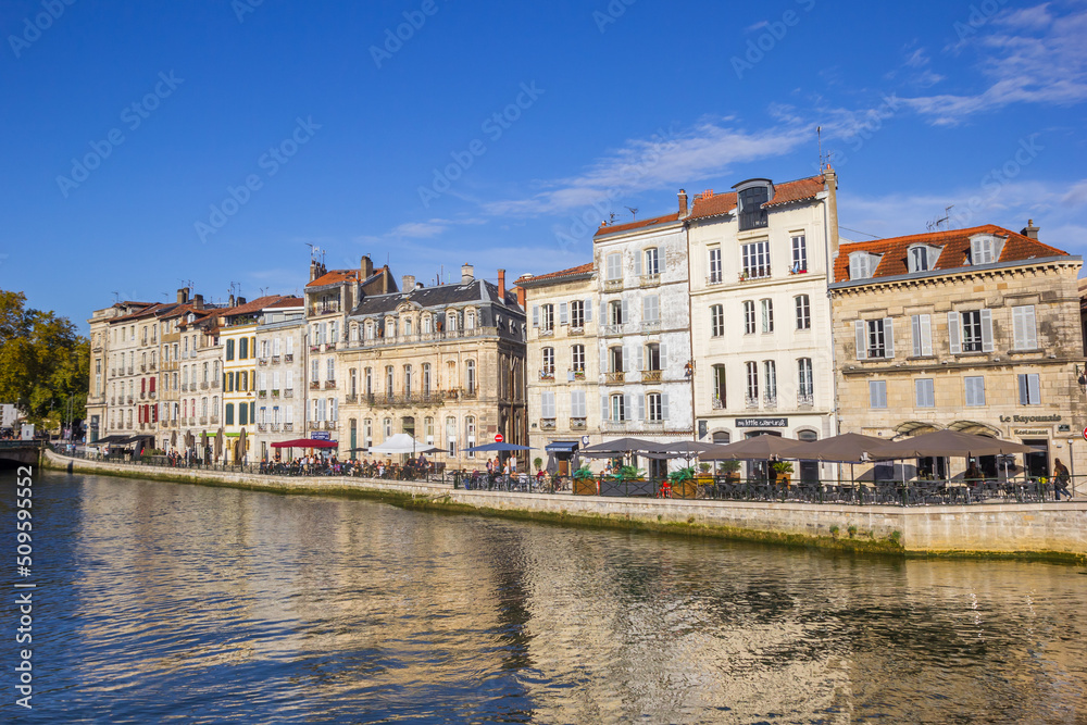 Historic houses reflected in the Nive river in Bayonne, France