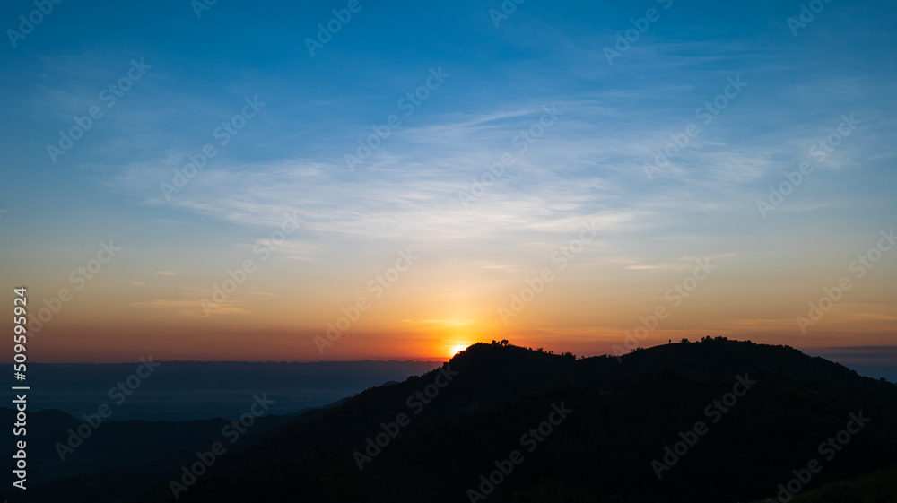 Silhouette of mountains during sunrise with sky and clouds. Beautiful natural landscape in the summertime Silhouette of mountains during sunrise with sky and clouds. Beautiful natural landscape in the summertime