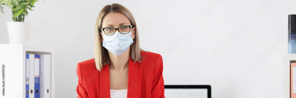 Cute manager in medical mask posing in office Cute manager in medical mask posing in office
