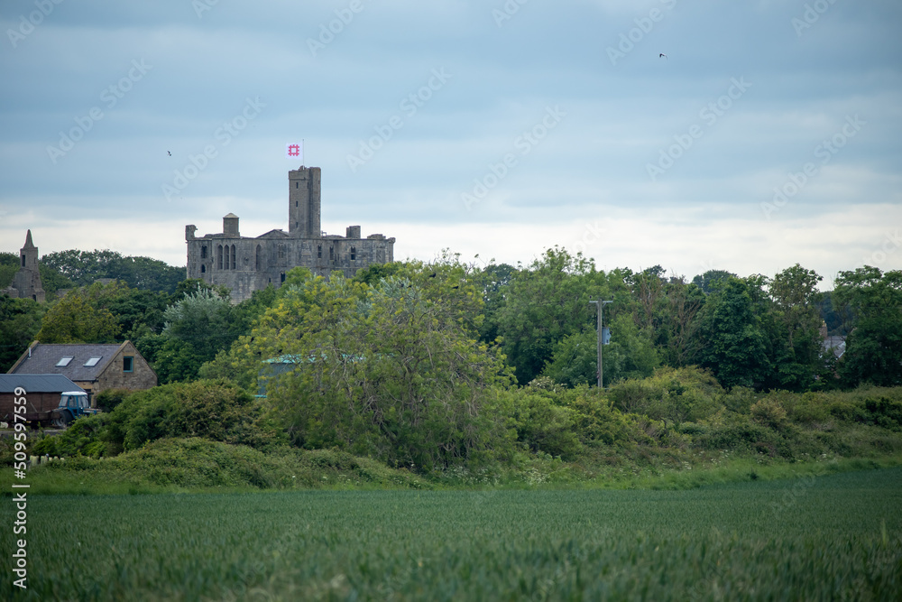 View of medieval Warkworth Castle from afar View of medieval Warkworth Castle from afar