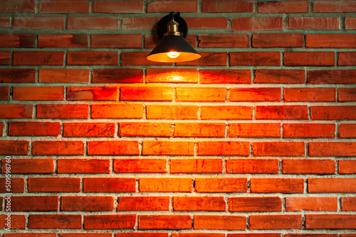 Lamp on brickwall with spot of warm light