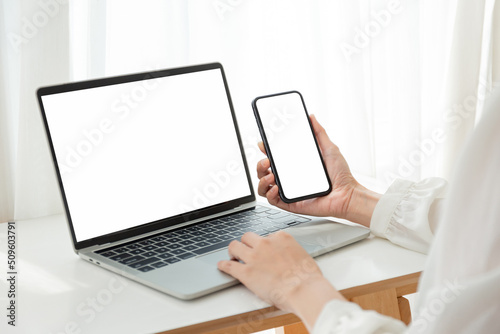 computer screen,cell phone blank mockup.hand woman work using laptop texting mobile.white background for advertising,contact business search information on desk in cafe.marketing,design