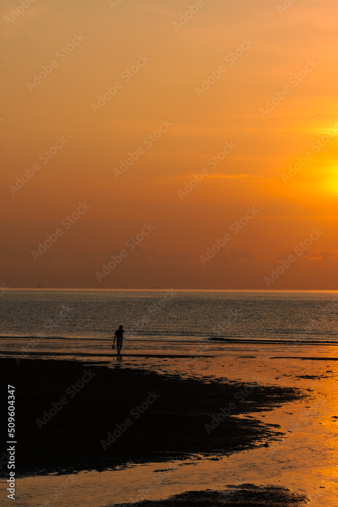 Silhouette of walking man against sunrise.. Silhouette of walking man against sunrise..