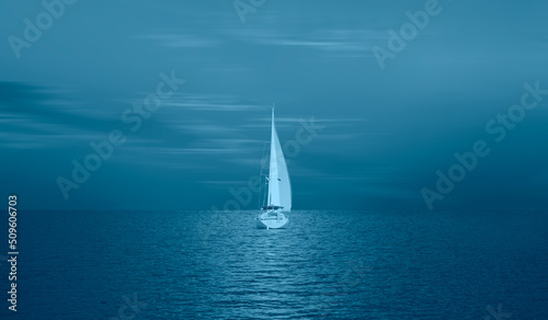 Lonely yacht sailing in the Mediterranean sea at amazing sunset - Sailing luxury yacht with white sails in the Sea. © muratart