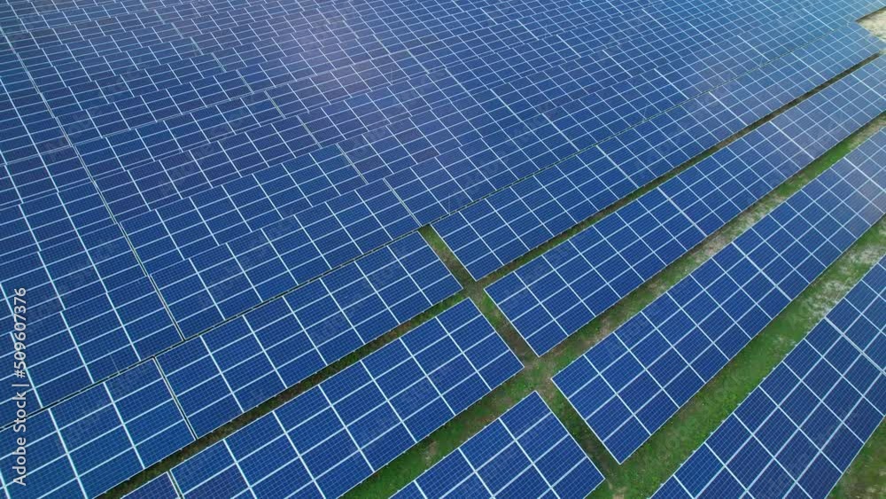 AERIAL Immense field of numerous solar collectors for producing electric energy. Photovoltaic power station as a means of generating electricity. Solar-powered technology for a more sustainable future AERIAL Immense field of numerous solar collectors for producing electric energy. Photovoltaic power station as a means of generating electricity. Solar-powered technology for a more sustainable future