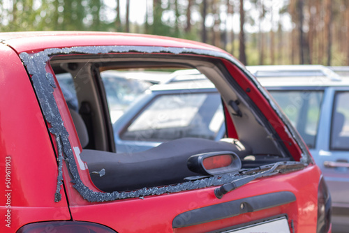 A car after an accident with a broken rear window. Broken window in a vehicle. The wreckage of the interior of a modern car after an accident, a detailed close-up view of the damaged car.