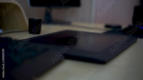 Close-up of hand drawing on a digital tablet with pen. Professional retoucher working on graphic tablet.