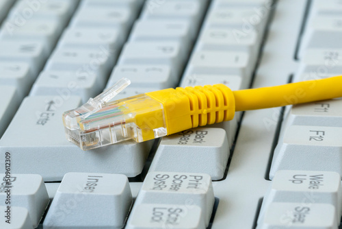 Internet cable, RJ45 plug on computer keyboard