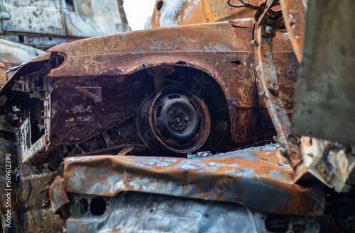 Broken and burned cars in the parking lot, accident or deliberate vandalism. Burnt car. Consequences of a car accident. Damaged by arson. Dump of civilian vehicles shot by Russian troops in Ukraine.