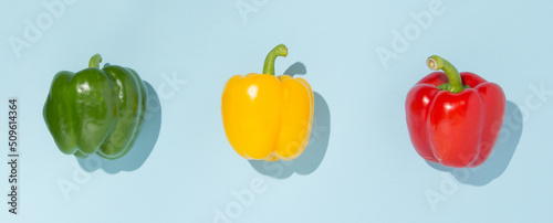 Green  yellow and red pepper on pastel background. Vegetable minimal concept.