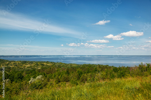 beautiful meadow on the hills with grass and flowers against the background of the sea and the sky