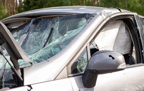 Close-up of a car with a broken windshield after a fatal crash. Consequence of a fatal car accident. Automobile danger. Reckless dangerous driving. Vehicle after an accident with a pedestrian.