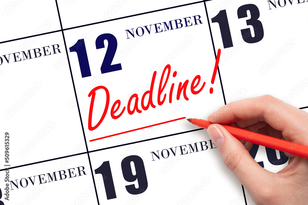 Hand drawing red line and writing the text Deadline on calendar date November 12. Deadline word written on calendar Hand drawing red line and writing the text Deadline on calendar date November 12. Deadline word written on calendar