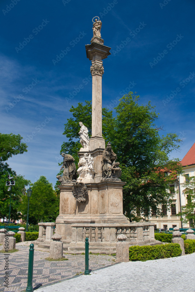 Sandstone Marian Plague Column in Hradčany. Prague town in summer cloudy day. Baroque architecture. Czech Republic.