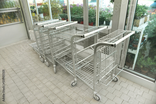Many empty metal shopping carts in garden center © New Africa