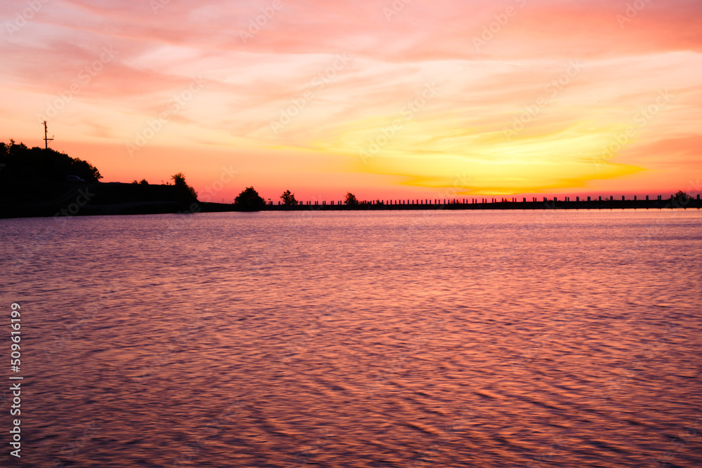 Naklejka premium sunset over the river