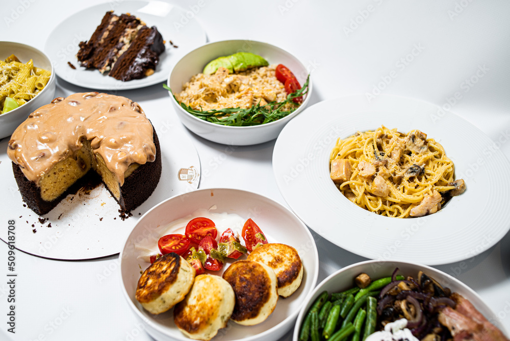 Set of festive meals of meat and vegetables and sweets on white background isolated. Menu set.