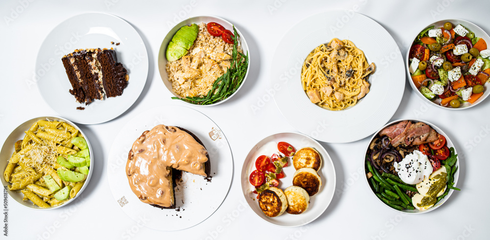 Set of festive meals of meat and vegetables and sweets on white background isolated. Menu set. Set of festive meals of meat and vegetables and sweets on white background isolated. Menu set.