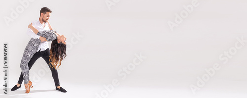 Banner social dance kizomba tango salsa people concept - couple dancing bachata on white background with copy space