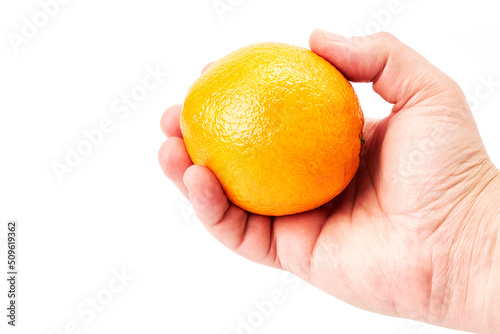 Hand of a man holding a nice juicy orange