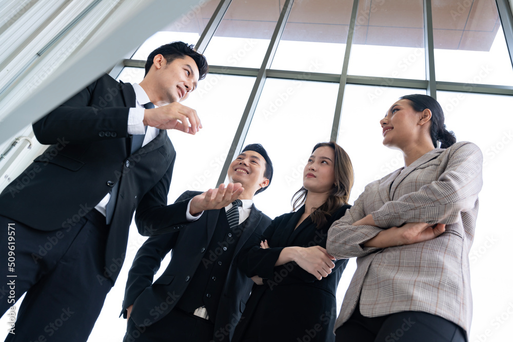 A group of Asian businessmen are gathering ideas to share ideas and offer ideas at a board in the office. with determination, determination and good fun A group of Asian businessmen are gathering ideas to share ideas and offer ideas at a board in the office. with determination, determination and good fun