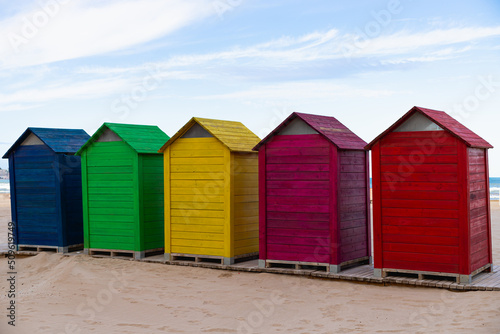 Colorful wooden houses on the beach © Iris