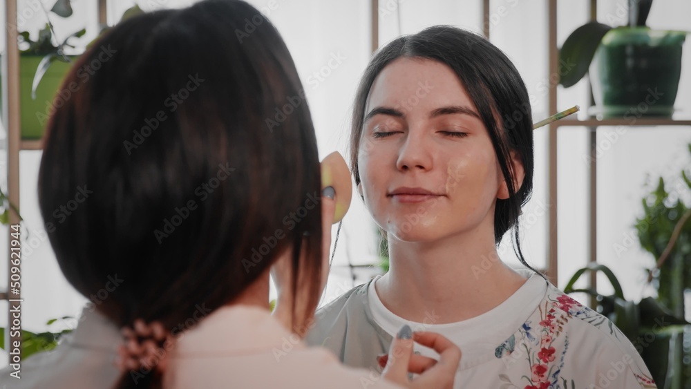 A young woman creates the image of a geisha for a girl. Makeup. Creating an image for an event A young woman creates the image of a geisha for a girl. Makeup. Creating an image for an event