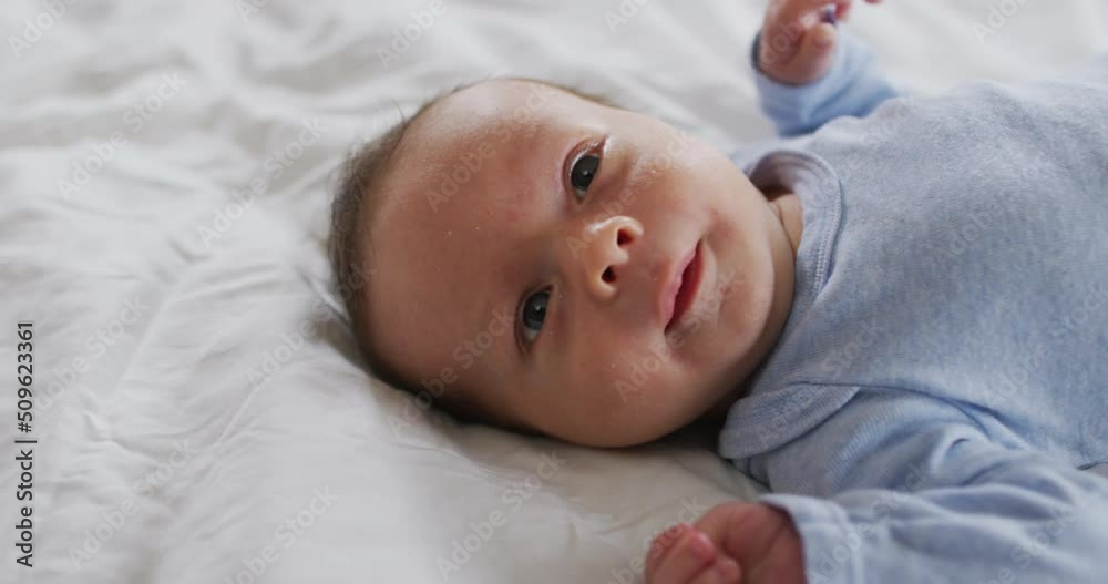 Video of caucasian newborn baby lying on bed Video of caucasian newborn baby lying on bed