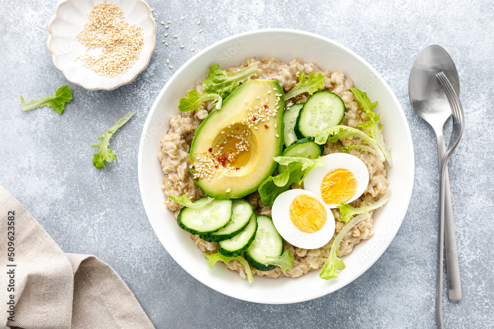 Oatmeal porridge with boiled egg, cucumber and avocado