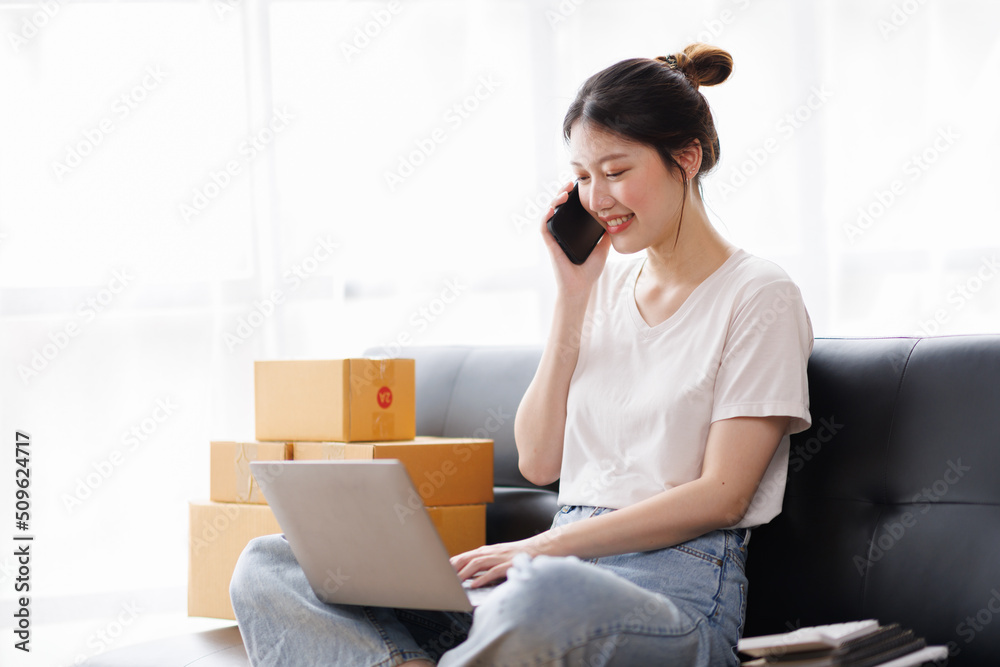Business digital online SME small business a new startup in the present for an online shop. Happy Young Asian woman have a warehouse used to send a customer Entrepreneur owner SME or freelance concept Business digital online SME small business a new startup in the present for an online shop. Happy Young Asian woman have a warehouse used to send a customer Entrepreneur owner SME or freelance concept