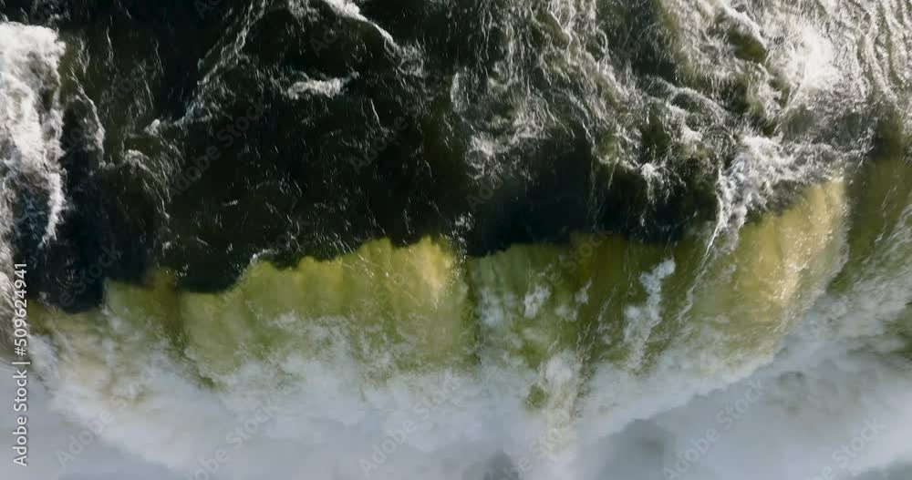 Spectacular circular aerial zoom out view of water gushing over the edge at the scenic Victoria falls. Unesco world heritage site Spectacular circular aerial zoom out view of water gushing over the edge at the scenic Victoria falls. Unesco world heritage site