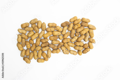 dry Unpeeled peanuts close up isolated on white background
