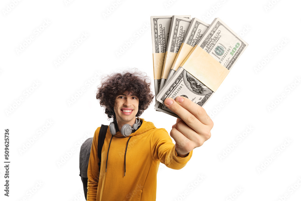 Cheerful male student carrying a backpack and showing stacks of money Cheerful male student carrying a backpack and showing stacks of money
