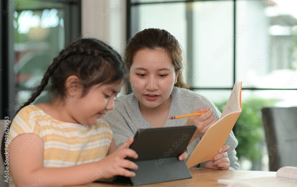 Asian girls study with a tutor, private lessons at home, sisters and sisters. Asian girls study with a tutor, private lessons at home, sisters and sisters.