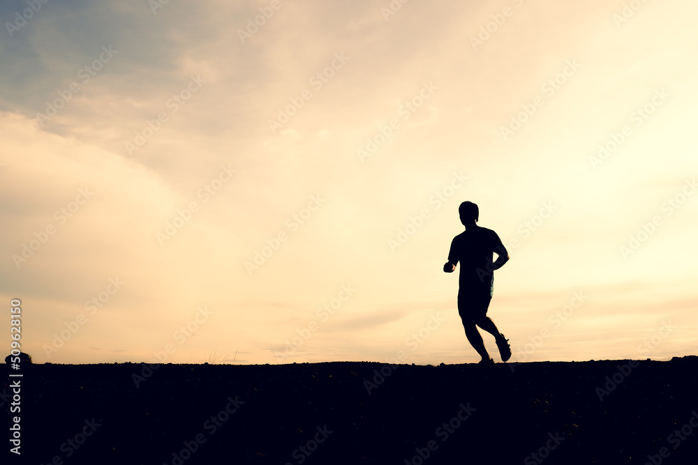 Silhouettes of men running happily in the evening. Travel and fitness concept