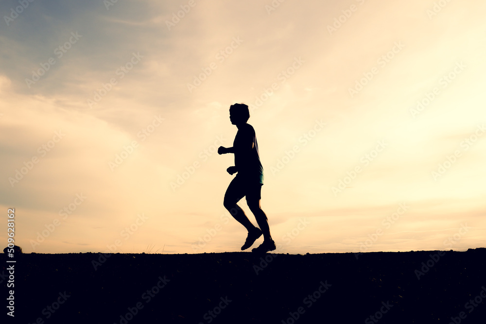 Silhouettes of men running happily in the evening. Travel and fitness concept