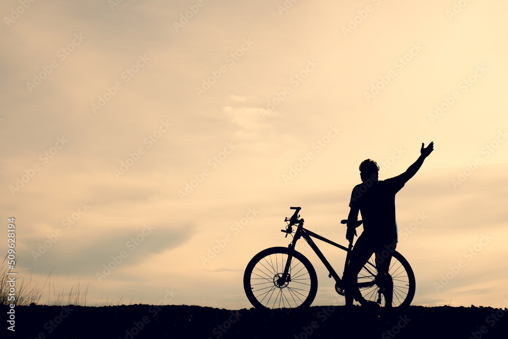 Silhouettes of mountain bikes and cyclists in the evening happily. Travel and fitness concept