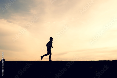 Silhouettes of men running happily in the evening. Travel and fitness concept © STOCK PHOTO 4 U