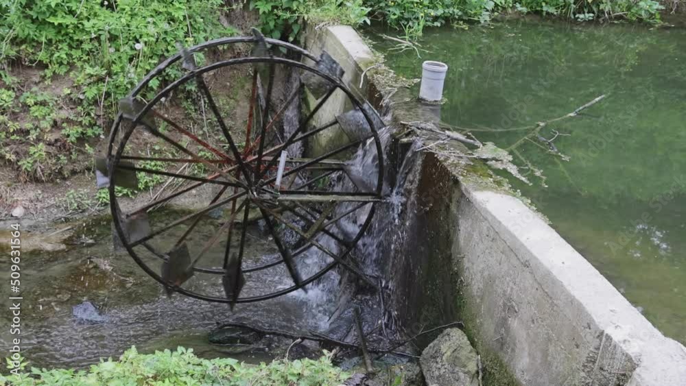 Rotating Water Wheel at Small River Stream Rotating Water Wheel at Small River Stream