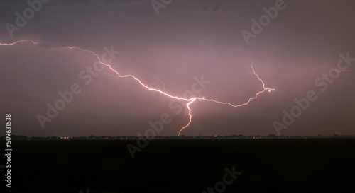 Powerful lightning strike at night in heavy rain