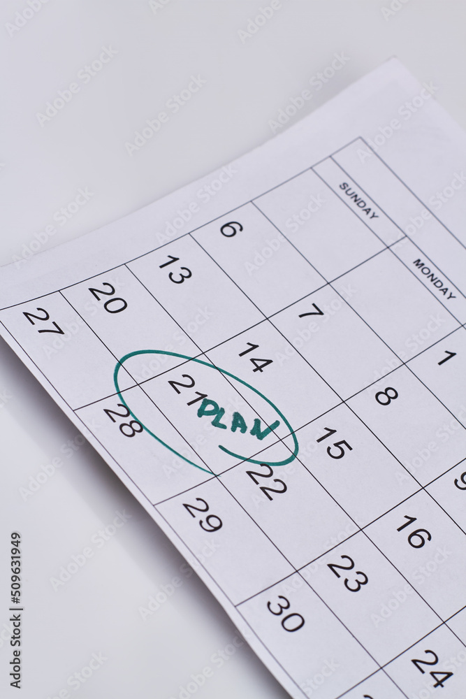 Vertical shot plan day marked in the calendar on white background. Top view flat lay. Vertical shot plan day marked in the calendar on white background. Top view flat lay.