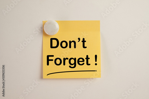 Don't Forget word on yellow stickynote on whiteboard use for meeting,reminder,notepaper,word graphic concept. photo