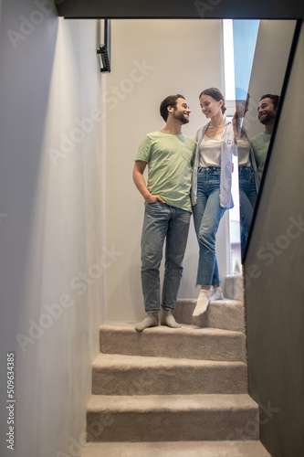 Man and woman looking at each other on stairs