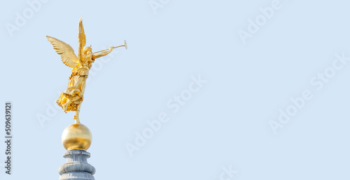 Fotografie Banner with old statue of a golden angel as a warrior and defender at the dome top in downtown of Dresden, Germany, with copy space blue sky solid background