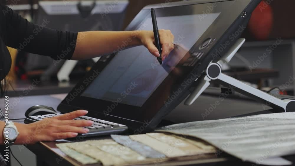 Drawing on a graphics tablet. The designer draws on a graphics tablet. Working with interactive pen display. closeup. Wallpaper production.