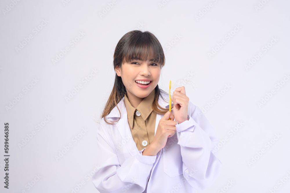 Young female dentist smiling over white background studio Young female dentist smiling over white background studio