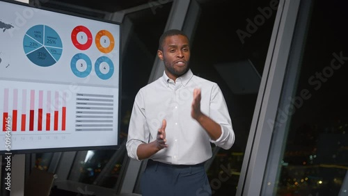 Wallpaper Mural Young african american professional answering questions after presentation using tv multiexposure late night in office Torontodigital.ca