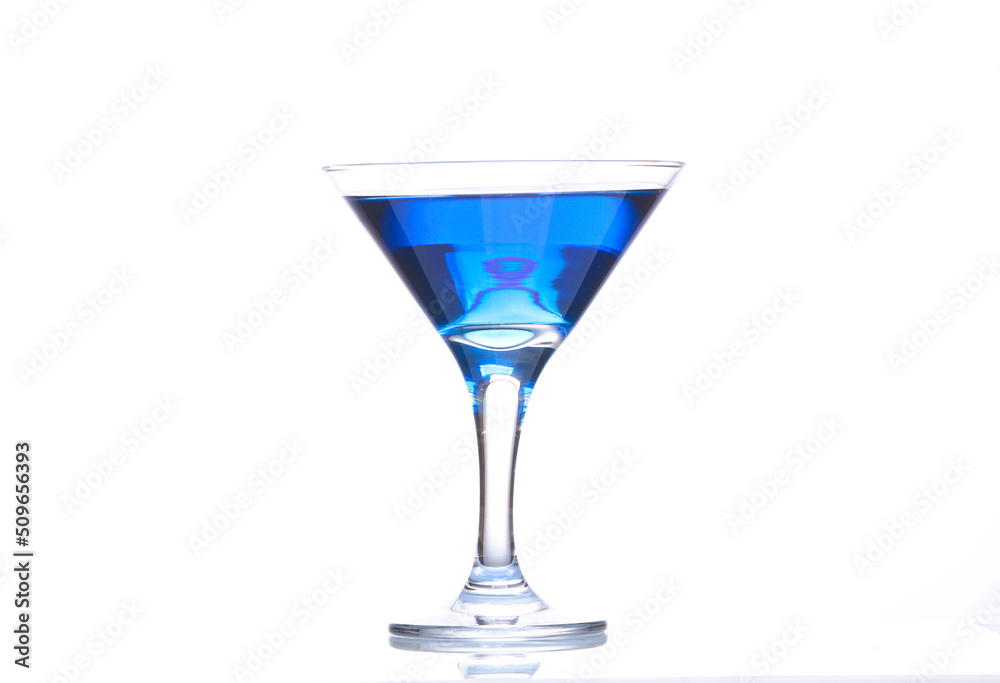Blue lagoon cocktail in martini glass isolated on white background